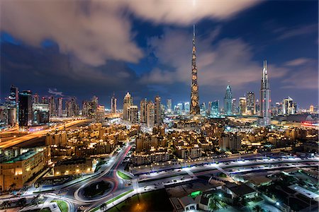 simsearch:649-07710299,k - Cityscape of Dubai, United Arab Emirates at dusk, with illuminated skyscrapers and the marina in the foreground. Stock Photo - Premium Royalty-Free, Code: 6118-09028208