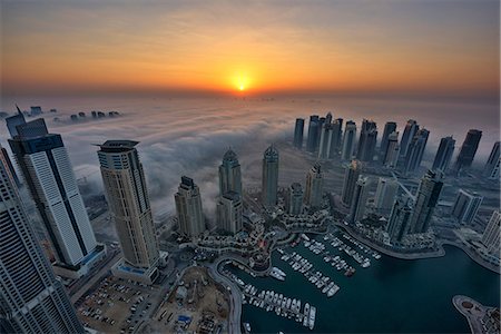 simsearch:649-07710299,k - Aerial view of the cityscape of Dubai, United Arab Emirates at dusk, with skyscrapers and the marina in the foreground. Stock Photo - Premium Royalty-Free, Code: 6118-09028218