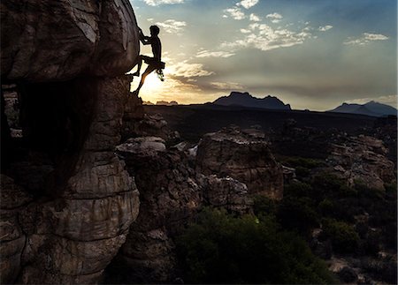 simsearch:6118-09039107,k - Mountaineer climbing a rock formation in a mountainous landscape. Stock Photo - Premium Royalty-Free, Code: 6118-09039109