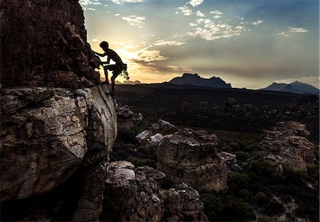 simsearch:6118-09039107,k - Mountaineer climbing a rock formation in a mountainous landscape. Stock Photo - Premium Royalty-Free, Code: 6118-09039111