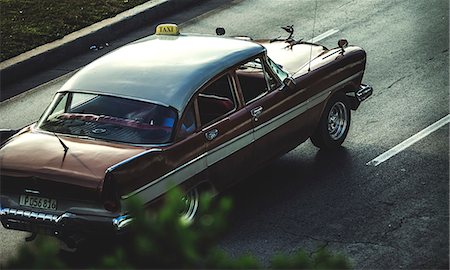 sedan (vehicle) - High angle shot of a classic 1950s car driving on a road. Stock Photo - Premium Royalty-Free, Code: 6118-09039117