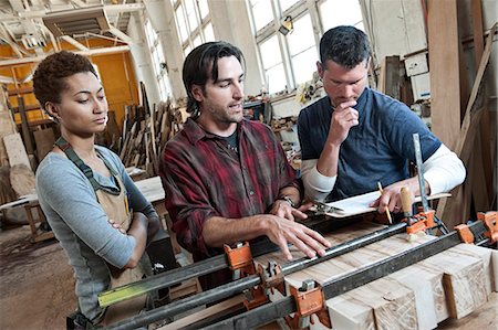 simsearch:6118-08660009,k - Team of multi-racial workers discussing an issue related to glueing a part together in a woodworking factory. Stock Photo - Premium Royalty-Free, Code: 6118-09140159