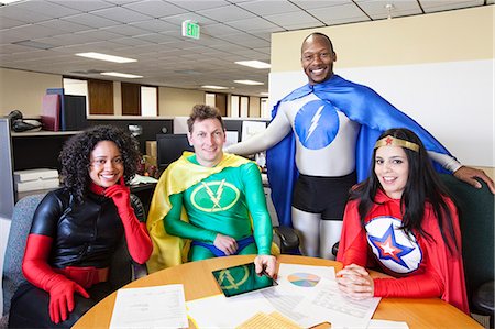 A mixed race team of office super hero's in their office. Stock Photo - Premium Royalty-Free, Code: 6118-09148021