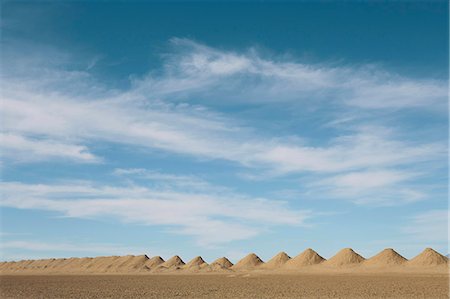 simsearch:630-06723923,k - Mining tailings creating row of dirt piles in desert. Stock Photo - Premium Royalty-Free, Code: 6118-09148356
