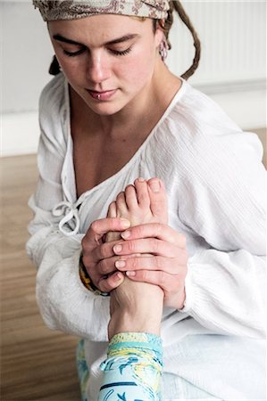 simsearch:400-04435419,k - Young woman wearing headscarf and white blouse sitting on floor in yoga pose. Stock Photo - Premium Royalty-Free, Code: 6118-09165853