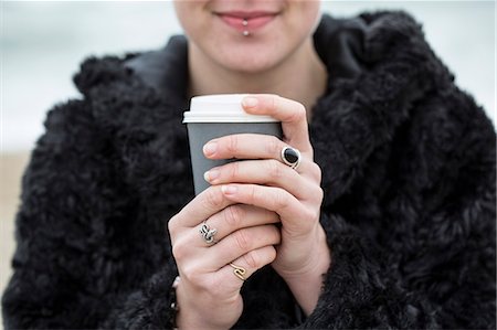 simsearch:400-04435419,k - Close up of young woman wearing black furry jacket holding paper cup with hot drink. Stock Photo - Premium Royalty-Free, Code: 6118-09165831