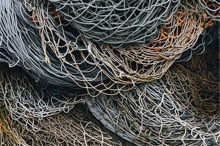 simsearch:6118-08910527,k - A heap of commercial fishing nets on the quayside. Stock Photo - Premium Royalty-Free, Code: 6118-09166282