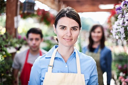 simsearch:6118-08660009,k - Staff of a garden centre nursery with a Caucasian woman employee in the lead. Stock Photo - Premium Royalty-Free, Code: 6118-09129766
