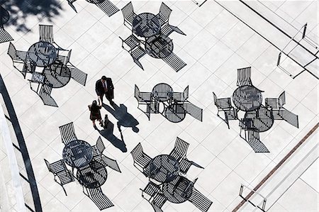 View from above of two business people meeting outside in an open air cafe area. Stock Photo - Premium Royalty-Free, Code: 6118-09129984