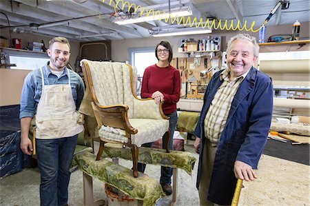 simsearch:6118-08660009,k - Senior Caucasian man upholsterer and his understudy team of young people working on an antique chair. Stock Photo - Premium Royalty-Free, Code: 6118-09130077