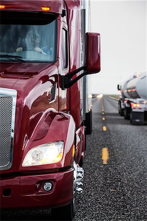 Close up view of the cab and driver of a  commercial truck on the highway. Stock Photo - Premium Royalty-Free, Code: 6118-09139545