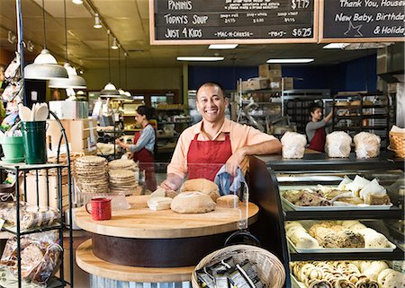 supermarket baker - Hispanic man baker and employees in the background of the bakery. Stock Photo - Premium Royalty-Free, Code: 6118-09139796