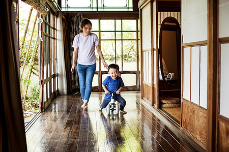 simsearch:400-06412547,k - Smiling Japanese woman and little boy on a tricycle on porch of traditional Japanese house. Stock Photo - Premium Royalty-Free, Code: 6118-09200348