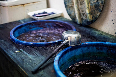 High angle close up of ladle and buckets with blue dye in a textile plant dye workshop. Stock Photo - Premium Royalty-Free, Code: 6118-09200446