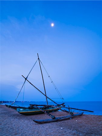 Traditional outrigger fishing boat (oruva) on Negombo Beach at night under the moon, Negombo, Sri Lanka, Asia Stock Photo - Premium Royalty-Free, Code: 6119-07451173