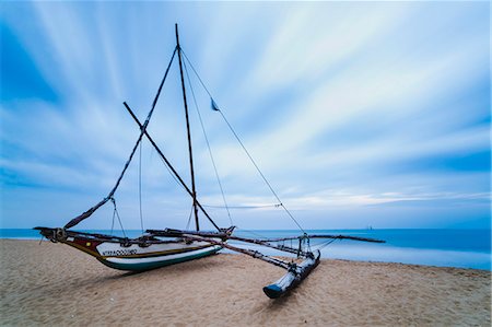 Outrigger fishing boat on Negombo Beach at sunrise, Sri Lanka, Asia Stock Photo - Premium Royalty-Free, Code: 6119-07451175