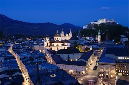 High angle view of the old town with Hohensalzburg Fortress, Dom Cathedral and Kappuzinerkirche Church at dusk, UNESCO World Heritage Site, Salzburg, Salzburger Land, Austria, Europe Stock Photo - Premium Royalty-Free, Code: 6119-07451858