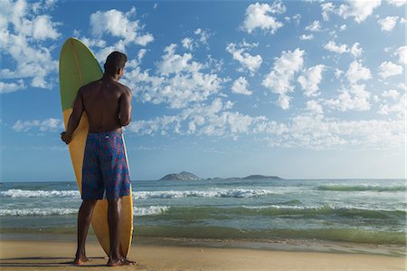 Young man with surfboard, Rio de Janeiro, Brazil, South America Stock Photo - Premium Royalty-Free, Code: 6119-07587497