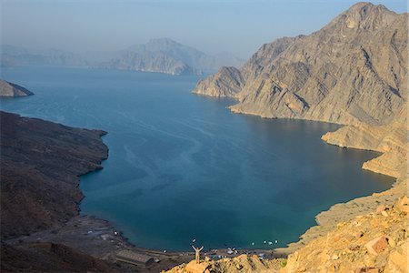 scaling - Woman at a viewing point over the Khor An-najd fjord, Musandam, Oman, Middle East Stock Photo - Premium Royalty-Free, Code: 6119-07744665