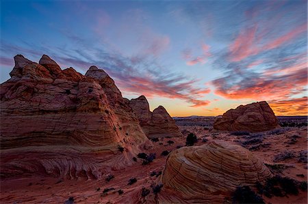 Orange clouds over sandstone cones, Coyote Buttes Wilderness, Vermilion Cliffs National Monument, Arizona, United States of America, North America Stock Photo - Premium Royalty-Free, Code: 6119-07845619