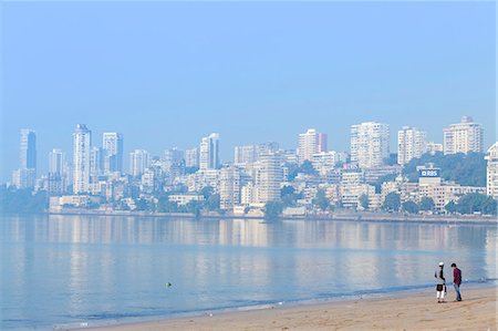 A Muslim and a Hindu man talking on Chowpatty beach with the skyscrapers of wealthy Malabar Hill behind, Mumbai, Maharashtra, India, Asia Stock Photo - Premium Royalty-Free, Code: 6119-08062028