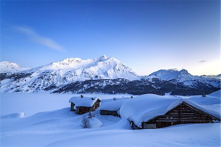 The blue hour leaving its place to the night over some scattered huts in Spluga by the Maloja Pass, Graubunden, Swiss Alps, Switzerland, Europe Stock Photo - Premium Royalty-Free, Code: 6119-08062108