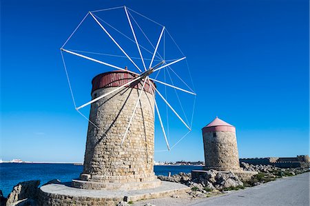 Medieval windmills at Mandraki harbour, City of Rhodes, Rhodes, Dodecanese Islands, Greek Islands, Greece, Europe Stock Photo - Premium Royalty-Free, Code: 6119-08126547