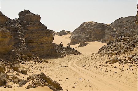 desert rocky and sand - Sandy trail leading through the desert, Tin Ghas, Southern Algeria, North Africa, AFrica Stock Photo - Premium Royalty-Free, Code: 6119-08269639