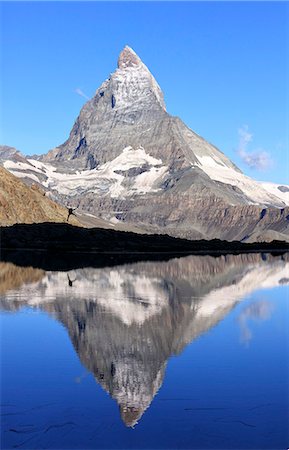 pennine alps - Hiker admiring the Matterhorn reflected in Lake Stellisee, Zermatt, Canton of Valais, Pennine Alps, Swiss Alps, Switzerland, Europe Stock Photo - Premium Royalty-Free, Code: 6119-08420430