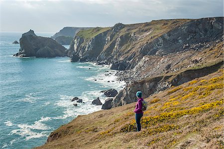 simsearch:600-05803652,k - A woman looks out over dramatic Cornish coastline near Kynance Cove on the Lizard Peninsula, Cornwall, England, United Kingdom, Europe Stock Photo - Premium Royalty-Free, Code: 6119-08797295