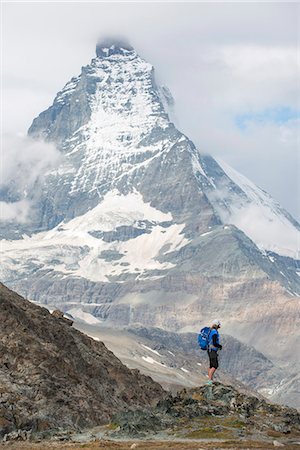 Hiking a trail in the Swiss Alps near Zermatt with a view of The Matterhorn in the distance, Zermatt, Valais, Switzerland, Europe Stock Photo - Premium Royalty-Free, Code: 6119-08797393