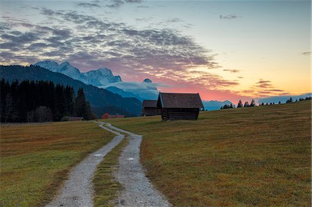 Sunset on wooden huts and meadows with the Alps in background, Geroldsee, Krun, Garmisch Partenkirchen, Upper Bavaria, Germany, Europe Stock Photo - Premium Royalty-Free, Code: 6119-09073948