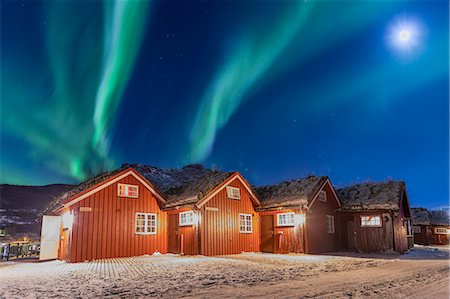 day - The Northern Lights (aurora borealis) and moon light up typical wood huts called Rorbu, Manndalen, Kafjord, Lyngen Alps, Troms, Norway, Scandinavia, Europe Stock Photo - Premium Royalty-Free, Code: 6119-09074083