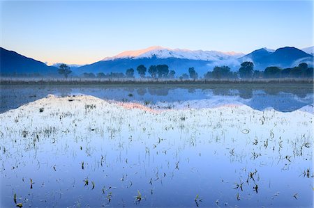 flood - Pink sky at dawn on the snowy peaks of Monti Lariani reflected in flooded land, Pian di Spagna, Valtellina, Lombardy, Italy, Europe Stock Photo - Premium Royalty-Free, Code: 6119-09074202