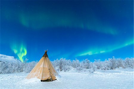dreamy night sky - Isolated Sami tent in the snow under Northern Lights (Aurora Borealis), Abisko, Kiruna Municipality, Norrbotten County, Lapland, Sweden, Scandinavia, Europe Stock Photo - Premium Royalty-Free, Code: 6119-09074216