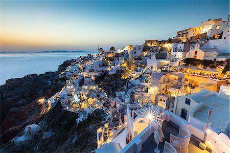 Sunset over the white stone buildings and windmills of Oia on the tip of Santorini's caldera, Santorini, Cyclades, Greek Islands, Greece, Europe Stock Photo - Premium Royalty-Free, Code: 6119-09074626