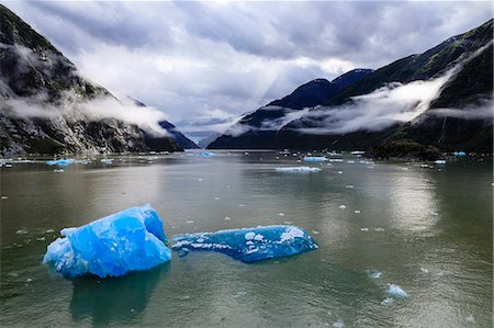 Spectacular Tracy Arm Fjord, brilliant blue icebergs and backlit clearing mist, mountains and South Sawyer Glacier, Alaska, United States of America, North America Stock Photo - Premium Royalty-Free, Code: 6119-09101714