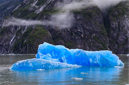 Tracy Arm Fjord, clearing mist, blue icebergs and cascades, near South Sawyer Glacier, Alaska, United States of America, North America Stock Photo - Premium Royalty-Free, Code: 6119-09101715