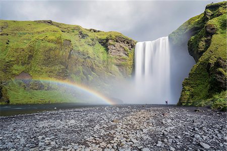 Double rainbow and tourists with hands in the air at Skogafoss waterfall in South Iceland, Polar Regions Stock Photo - Premium Royalty-Free, Code: 6119-09127084