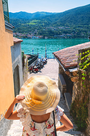 scooter rear view - Woman with hat on Monte Isola, the largest lake island in Europe, Province of Brescia, Lombardy, Italy, Europe Stock Photo - Premium Royalty-Free, Code: 6119-09214243