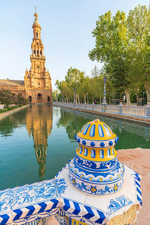 Old tower seen from the decorated ceramics balustrade along the canal, Plaza de Espana, Seville, Andalusia, Spain, Europe Stock Photo - Premium Royalty-Free, Code: 6119-09238673