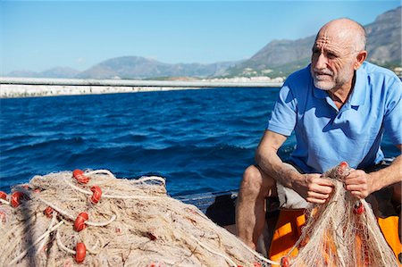 simsearch:400-05676936,k - Fisherman holding nets Stock Photo - Premium Royalty-Free, Code: 6122-07691677