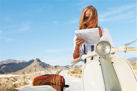 road map - Woman Sitting on motorbike with map Stock Photo - Premium Royalty-Free, Code: 6122-07692065