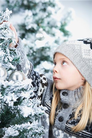 snow christmas tree white - Girl decorating a christmas tree Stock Photo - Premium Royalty-Free, Code: 6122-07692830
