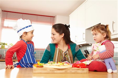 simsearch:649-05950793,k - Mother cooking with children in kitchen Stock Photo - Premium Royalty-Free, Code: 6122-07692968