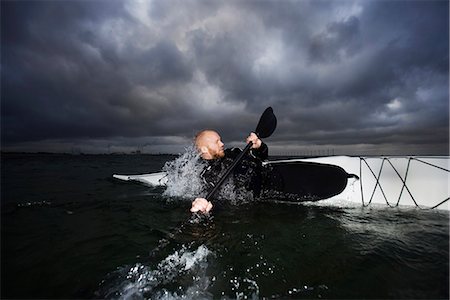 sea sports with boat - Man in kayak rotating Stock Photo - Premium Royalty-Free, Code: 6122-07692934