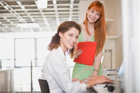 simsearch:649-05648787,k - Smiling businesswomen working together Stock Photo - Premium Royalty-Free, Code: 6122-07693978