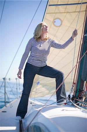 simsearch:614-00602699,k - Smiling woman adjusting sails on boat Stock Photo - Premium Royalty-Free, Code: 6122-07694035