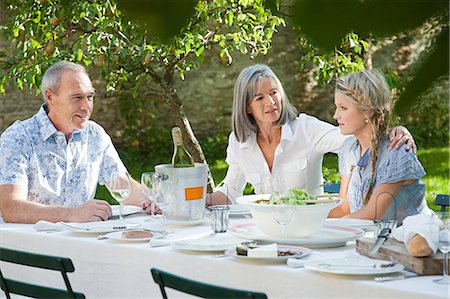 senior man lunch family - Family outdoors, mother with arm around daughter Stock Photo - Premium Royalty-Free, Code: 6122-07695636