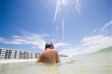 preteen boy shirtless - Boy sitting in sea on vacation Stock Photo - Premium Royalty-Free, Code: 6122-07695781